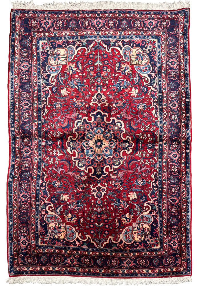 Full view of a Persian Sarough rug displaying intricate designs and a border pattern, with the texture of the shimmering wool visible Full view of a Persian Sarough rug displaying intricate designs and a border pattern, with the texture of the shimmering wool visible