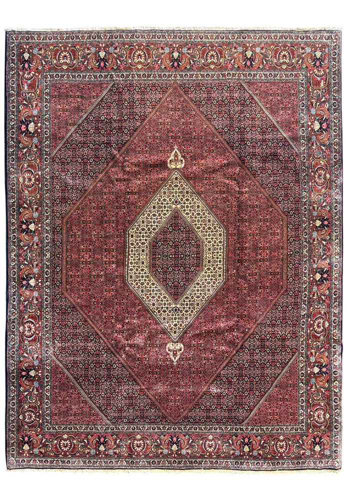 Overhead view of a 9'8 x 12'6 Persian Bijar rug showcasing the entire pattern with a central medallion and ornate borders in deep red and cream hues Overhead view of a 9'8 x 12'6 Persian Bijar rug showcasing the entire pattern with a central medallion and ornate borders in deep red and cream hues