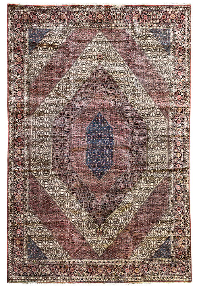 An intricate Persian Bijar rug displaying a central diamond medallion surrounded by complex floral patterns on a red and navy background, complete with traditional fringe.