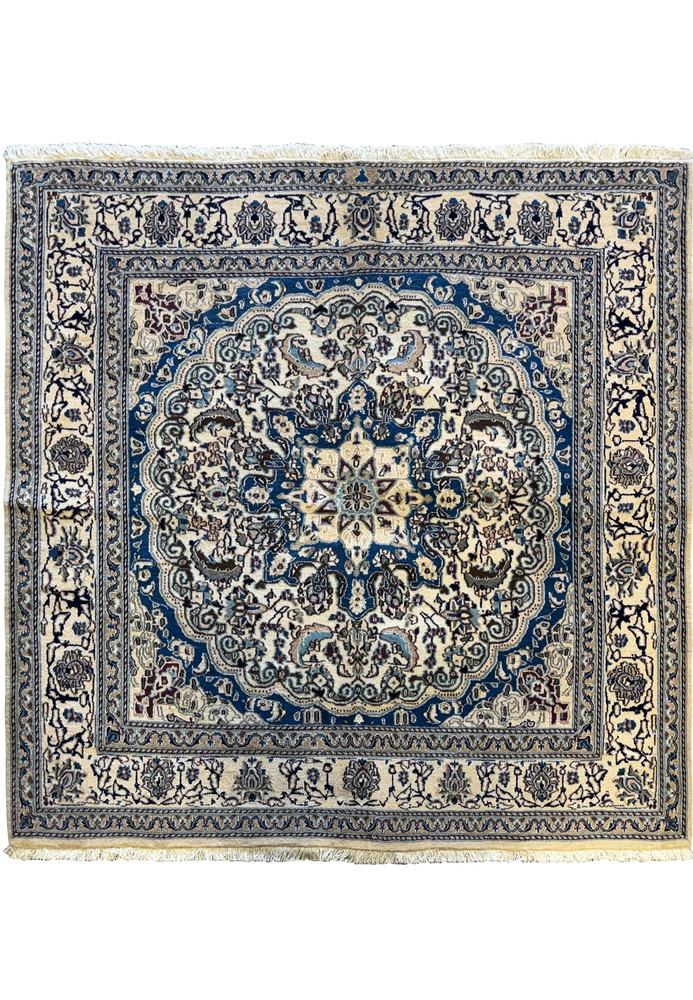 Overhead view of a 6'3 x 6'7 Persian Nain Square Rug featuring intricate blue and ivory floral patterns with a central medallion. Overhead view of a 6'3 x 6'7 Persian Nain Square Rug featuring intricate blue and ivory floral patterns with a central medallion.
