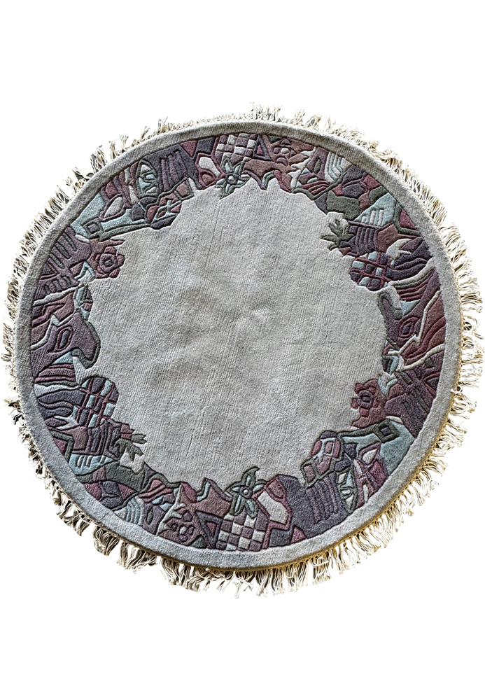 4'9 x 4'9 round modern Nepal rug made from Tibetan sheep wool, featuring intricate geometric border patterns and soft, muted colors.