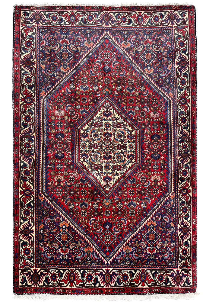 Authentic 3'3 x 5 Persian Gholtogh tribal rug with deep red field, ivory central medallion, bold geometric motifs, and richly patterned borders.