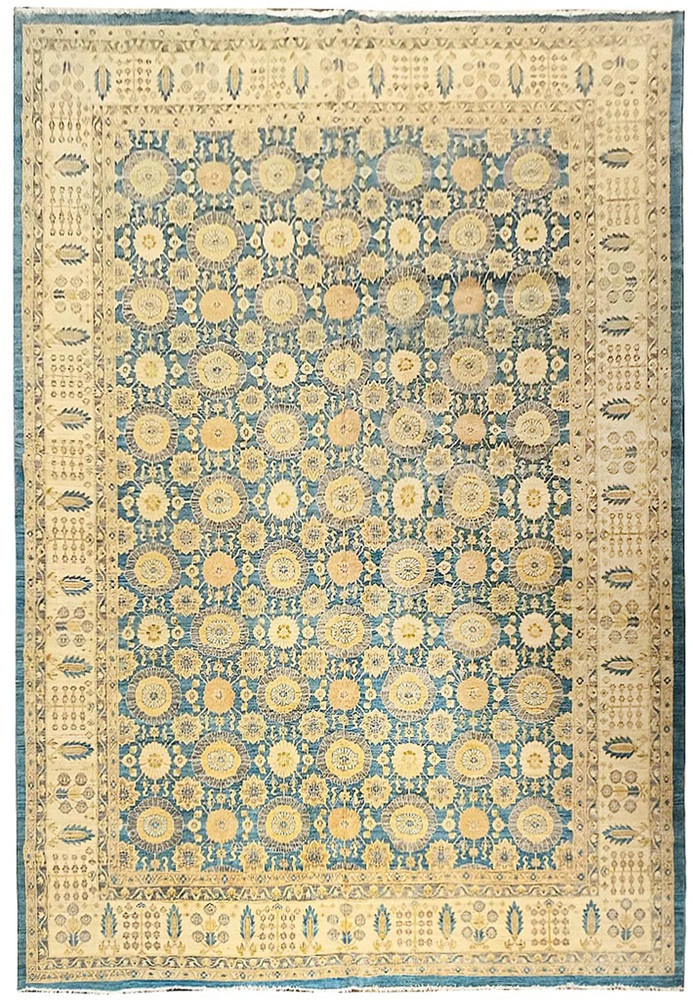 Full view of an 11'7 x 16'5 light blue Oriental Chobi Peshawar rug with repeating floral medallions, beige and cream details, and a wide decorative border