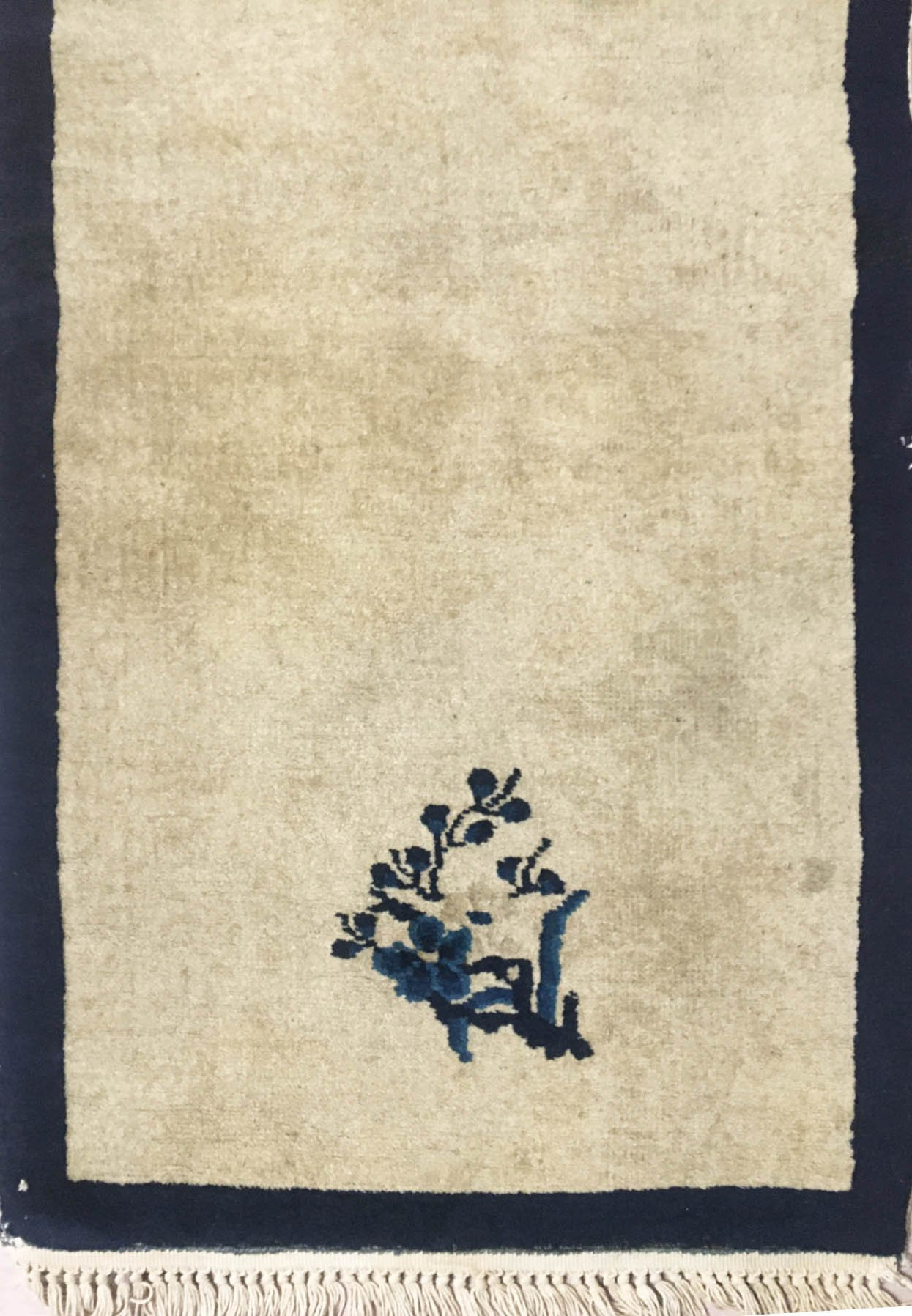 Detailed close-up of the intricate weaving and patterns on the vintage Oriental runner rug.