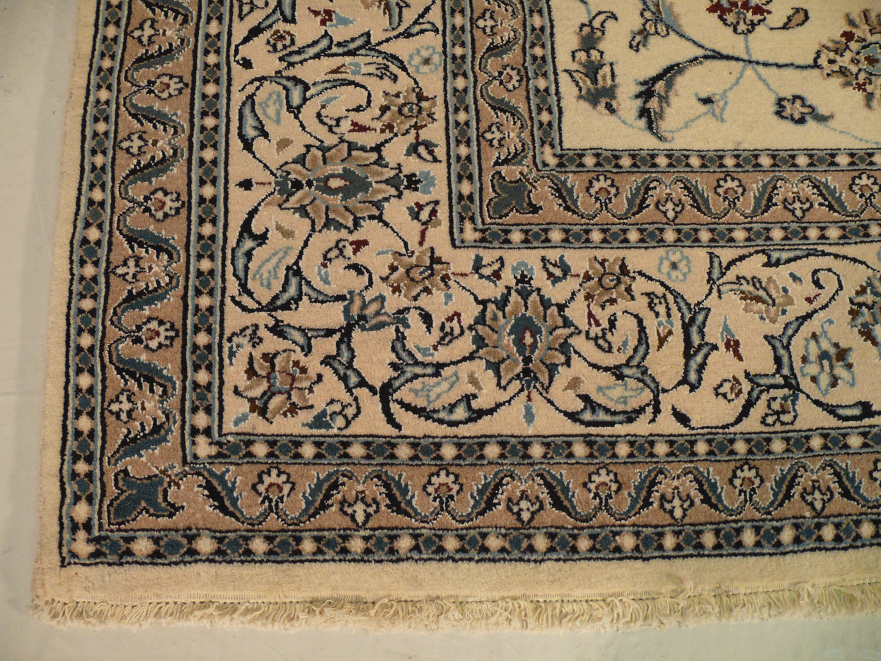 Detail shot of wine red flower accent outlined in navy blue over beige field