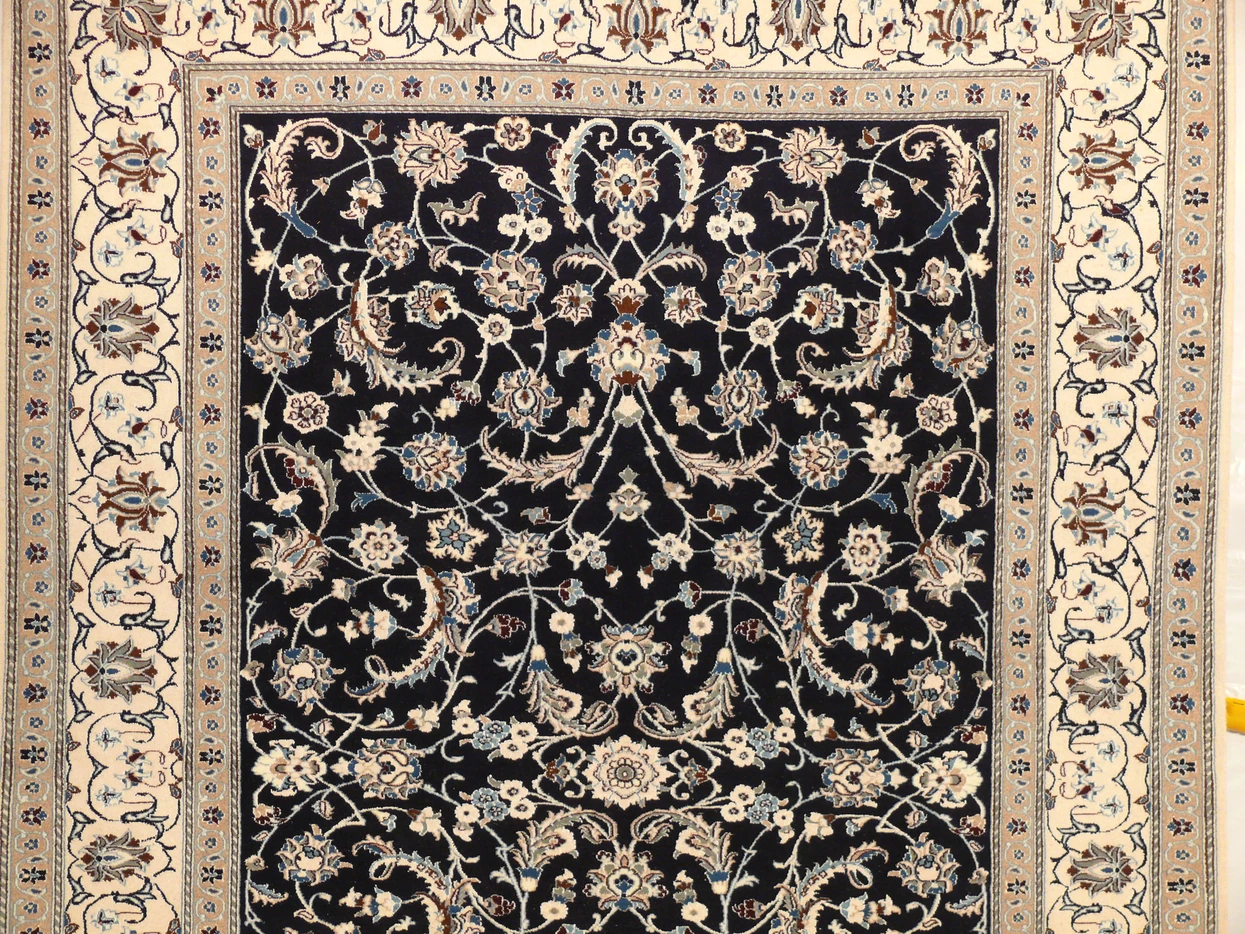 Close-up detail showing the fine silk and wool weave of the Persian Nain rug