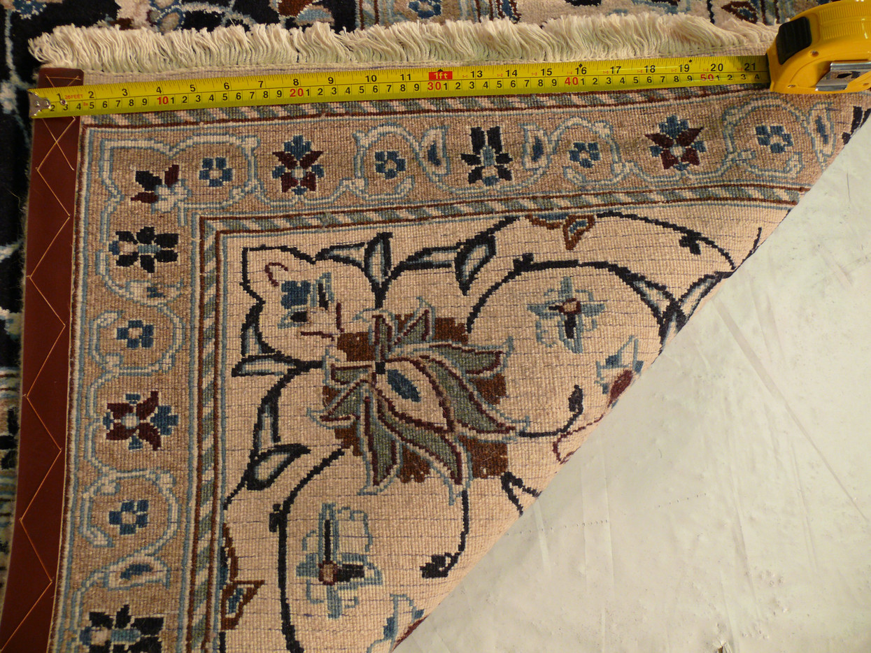 Zoomed into the back of the 8x11 Persian Nain Rug with a ruler to measure the density of the weave.