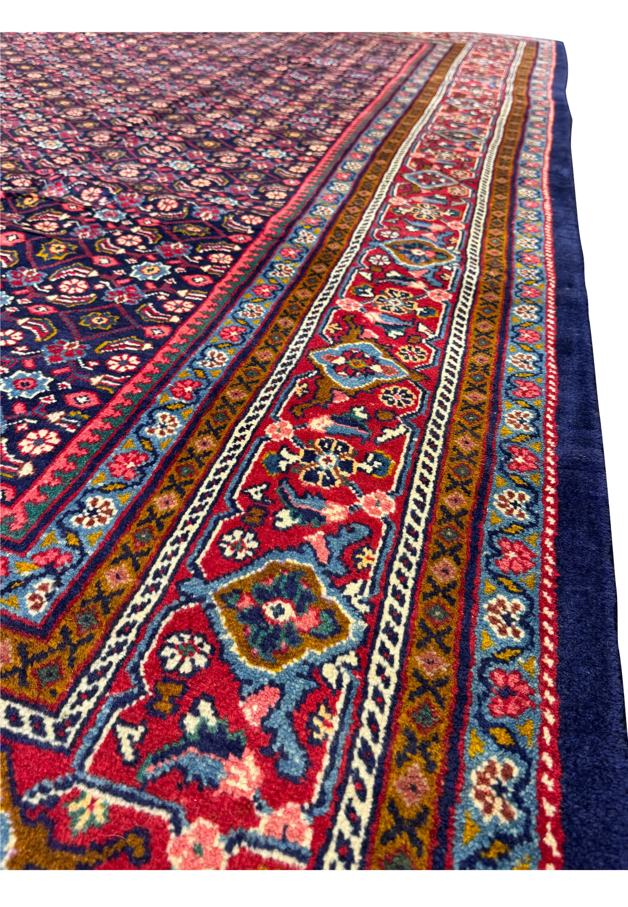 Perspective view of the 9'8 x 13'2 Persian Mahal Rug spread on the floor
