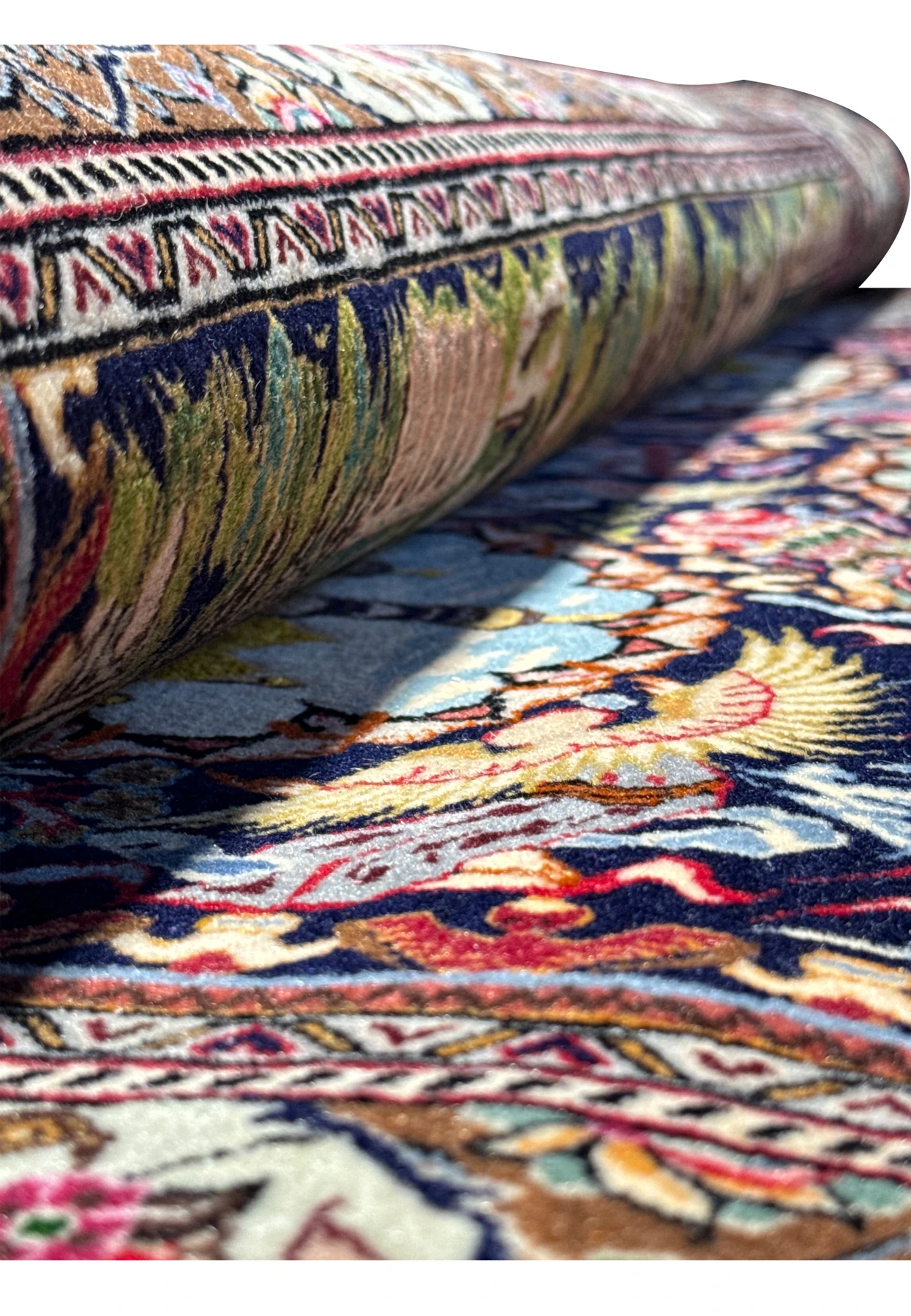 Rolled Persian Tabriz rug, highlighting the fine texture and quality of the weaving