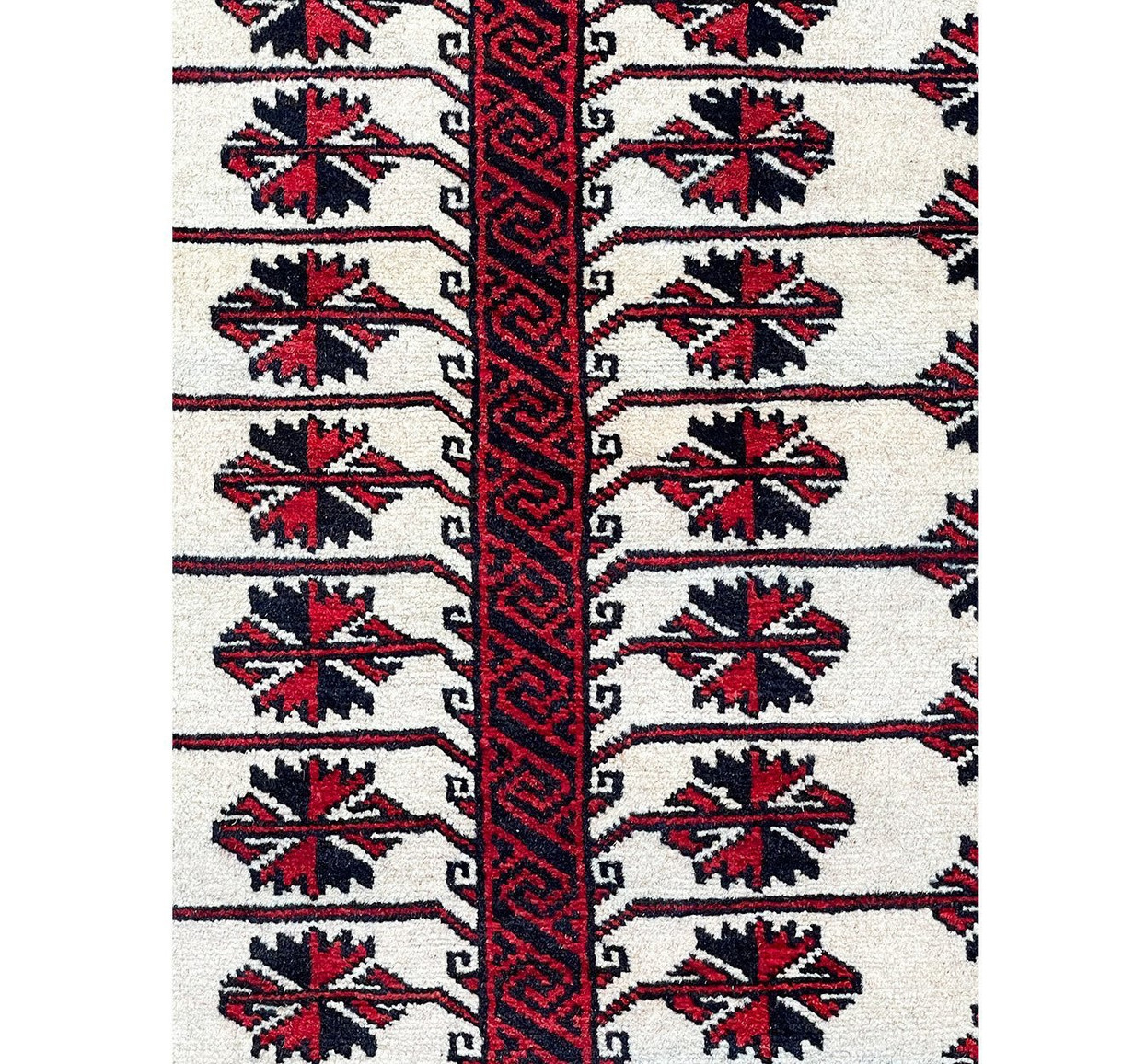 Detailed shot of the diamond-shaped motifs in the middle field of the Persian Baluch rug, highlighting its unique design