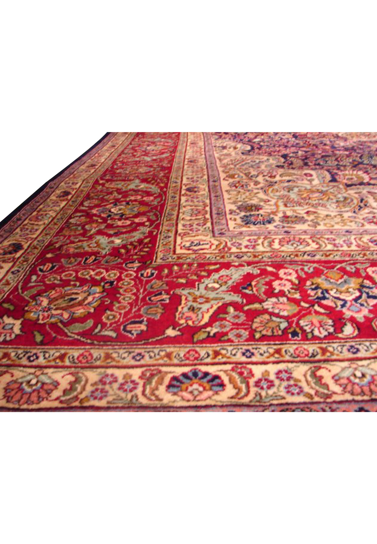 Persian Mashad rug displaying rich color contrasts with its central dark blue field and surrounding ornate floral motifs