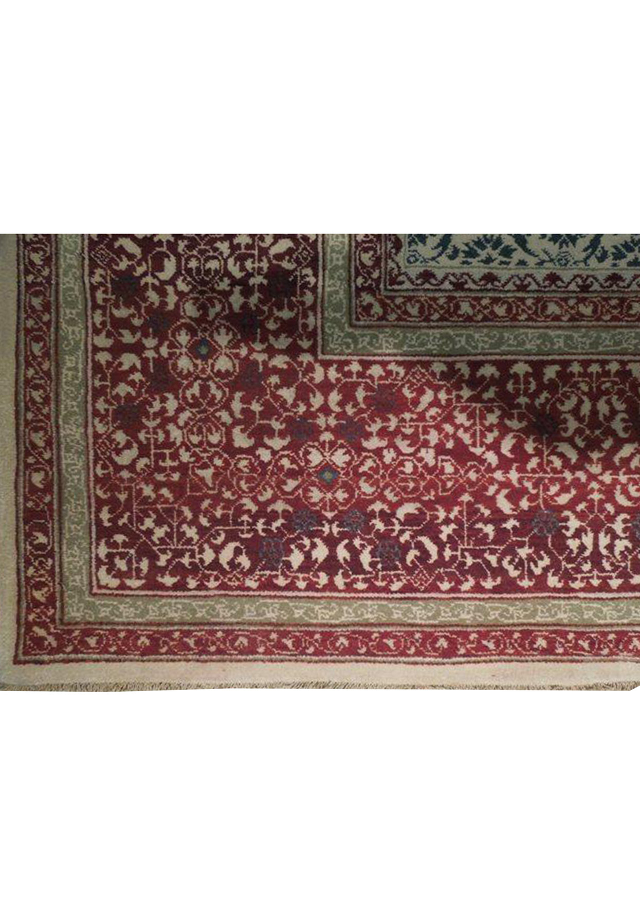 Close-up detail of the Oriental Agra rug's edge, displaying the tight weave and quality fringe along with the signature of authenticity
