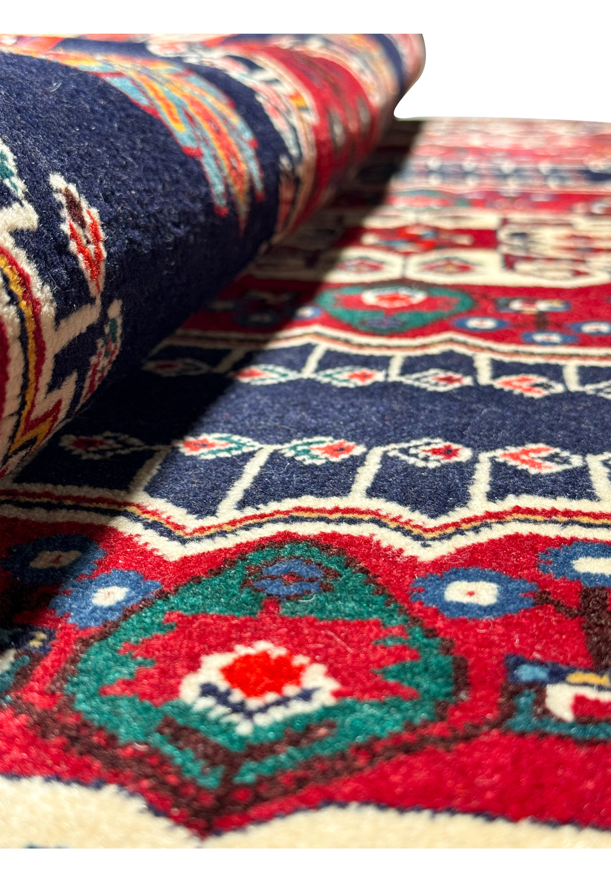 Perspective shot of a Persian Qashqai rug with a focus on the texture and weave, showcasing the vibrant colors and traditional design