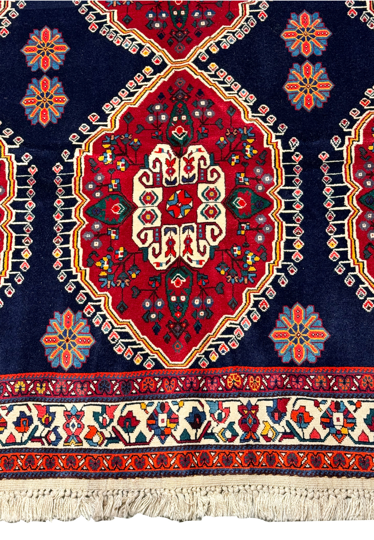 Partial view of a Persian Qashqai rug focusing on the central medallion pattern, floral motifs, and part of the ornate border