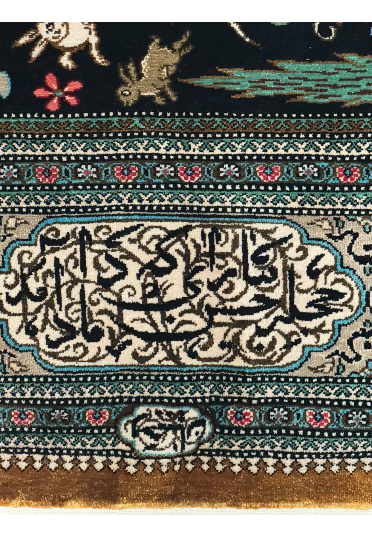 Lower border detail of Persian Qum Silk Hunting Rug, focusing on the complex weave and ornate patterns in high-quality silk
