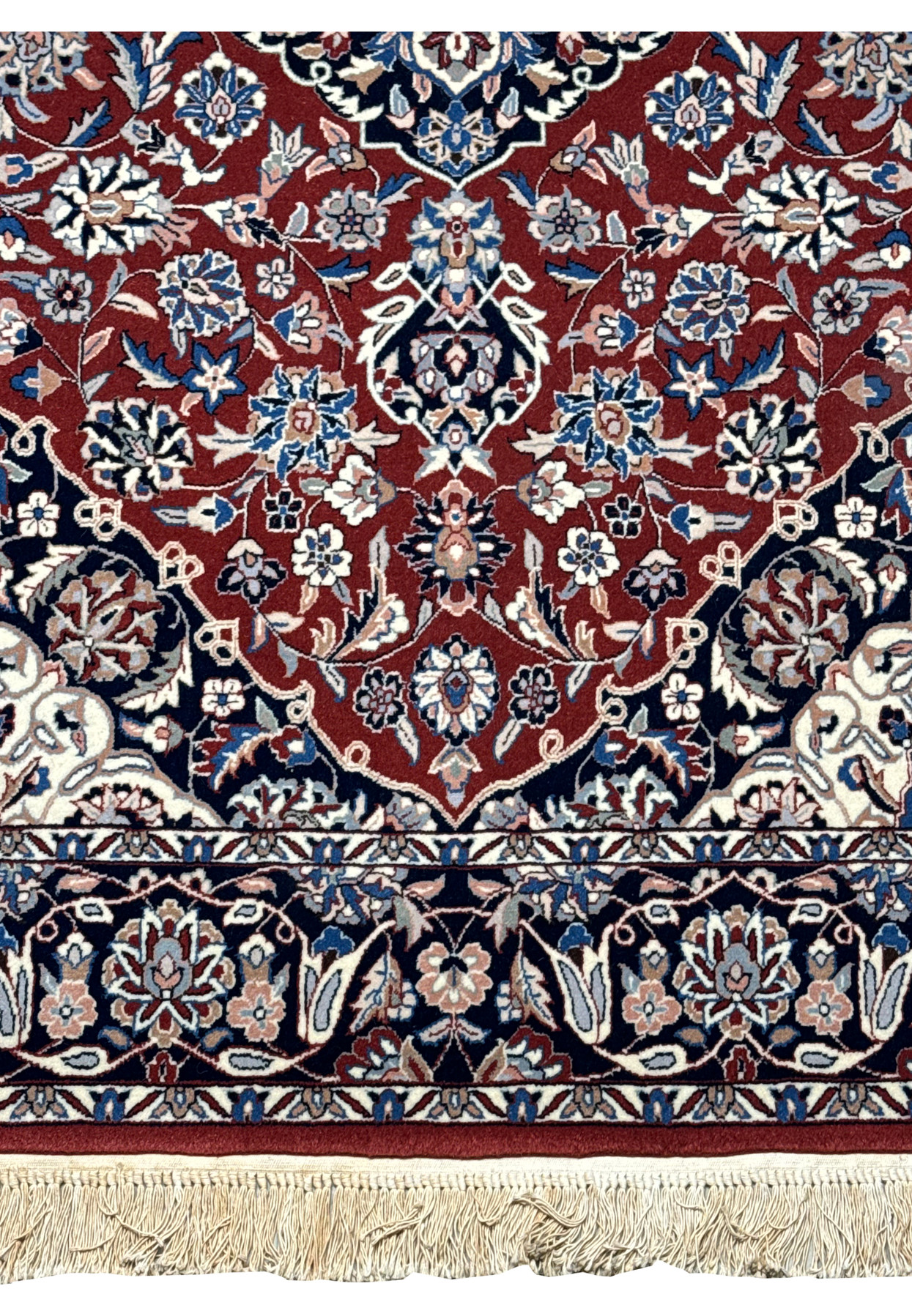 Close-up of Persian Isfahan rug displaying woven floral details and silk accents