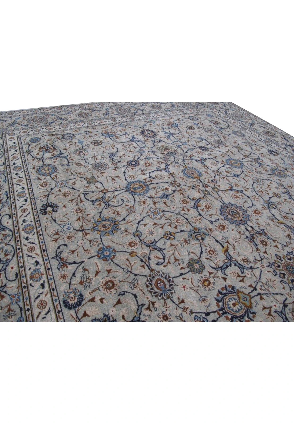 Close-up of the delicate and detailed floral motifs on a 11 x 18 Persian Kashan rug