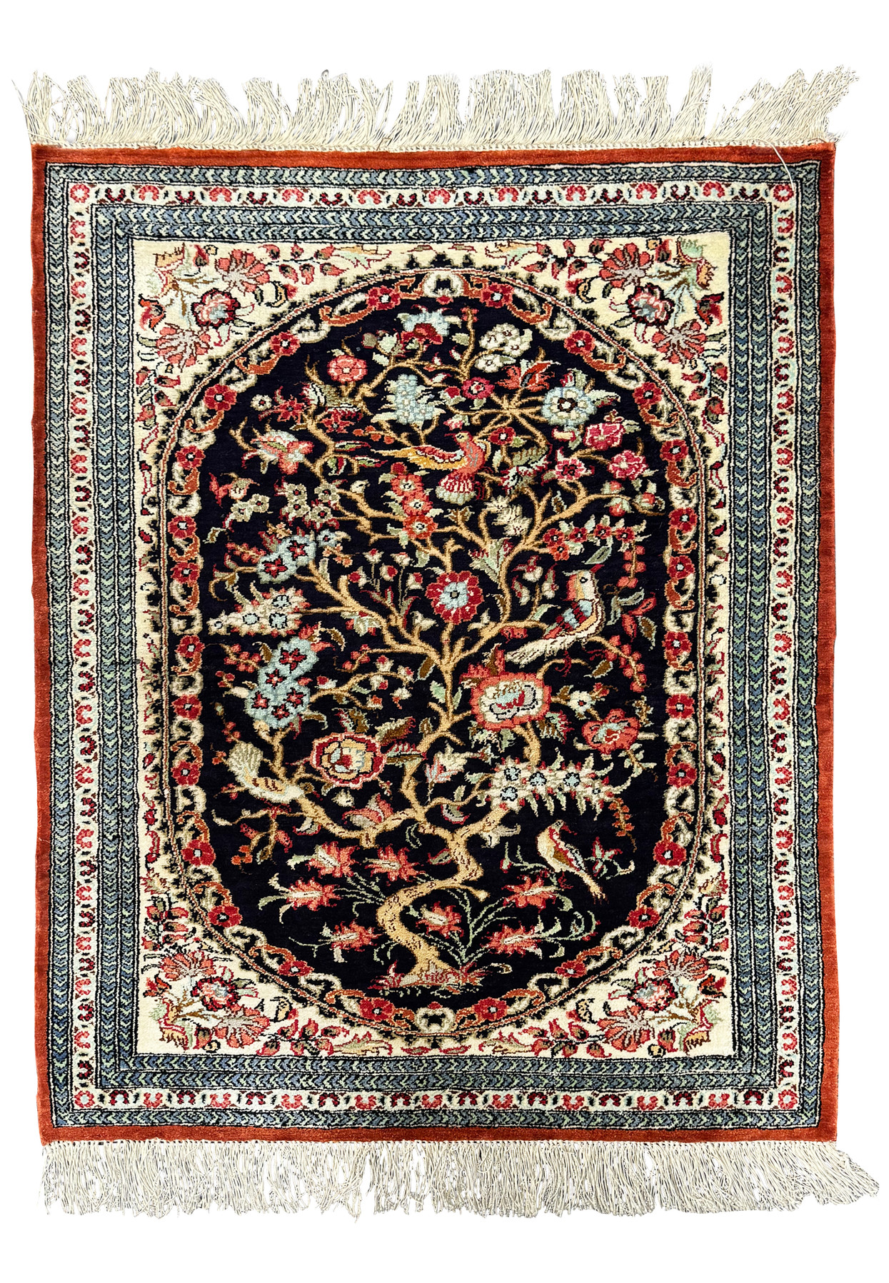 Close-up of the intricate floral design on a Persian Qum silk rug, showcasing the fine details and vibrant color palette