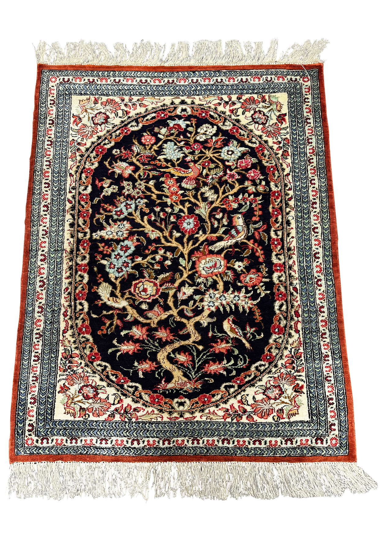 Persian Qum silk rug laid out to display the full extent of the elaborate floral patterns and the lustrous sheen of the silk