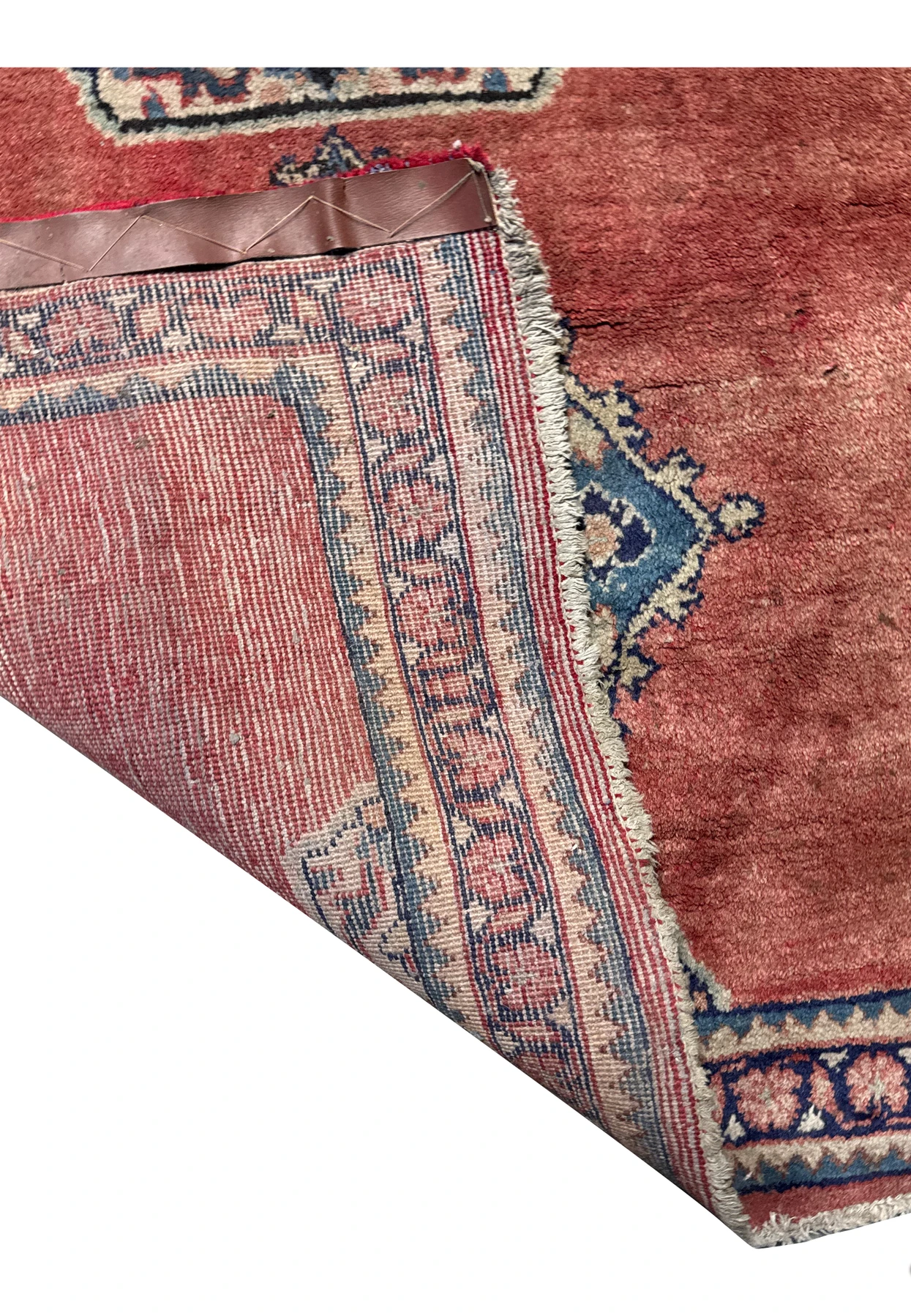 Underside view of a Persian Hamedan runner rug showing the tight weave and knots