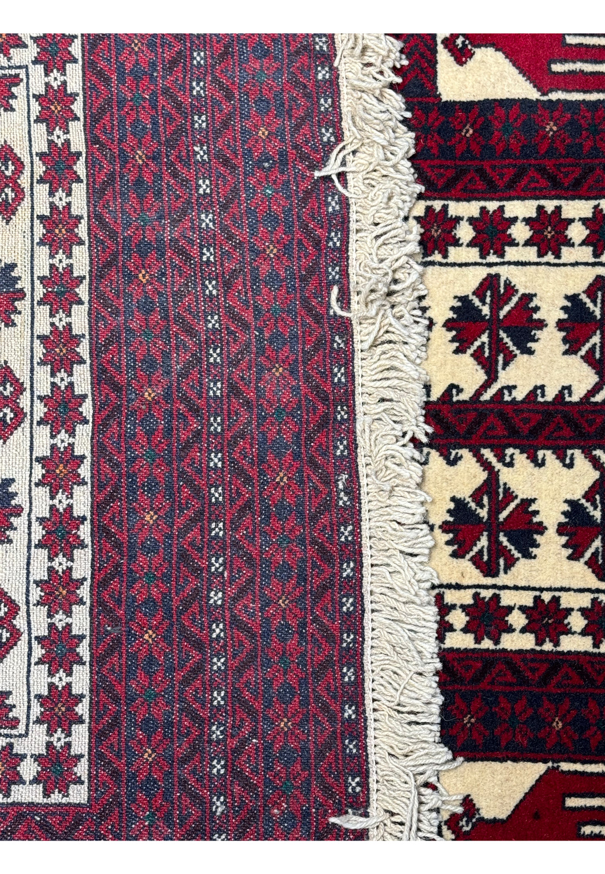 Corner detail of the Persian Baluch Prayer Rug, displaying the precision of the border designs."