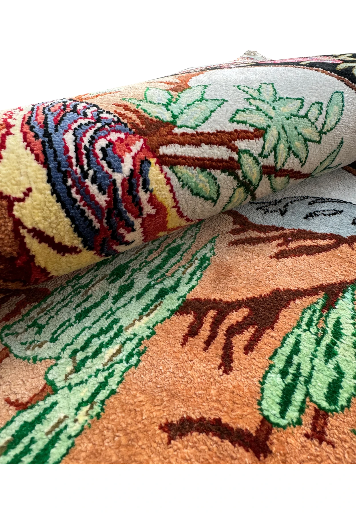 A rolled-up Persian Qum silk rug, emphasizing the thickness and quality of the silk pile