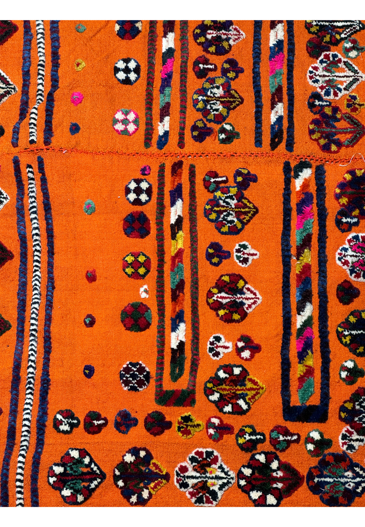 Close-up of traditional motifs on a Persian Qashqai Horse Cover Rug with vivid orange background