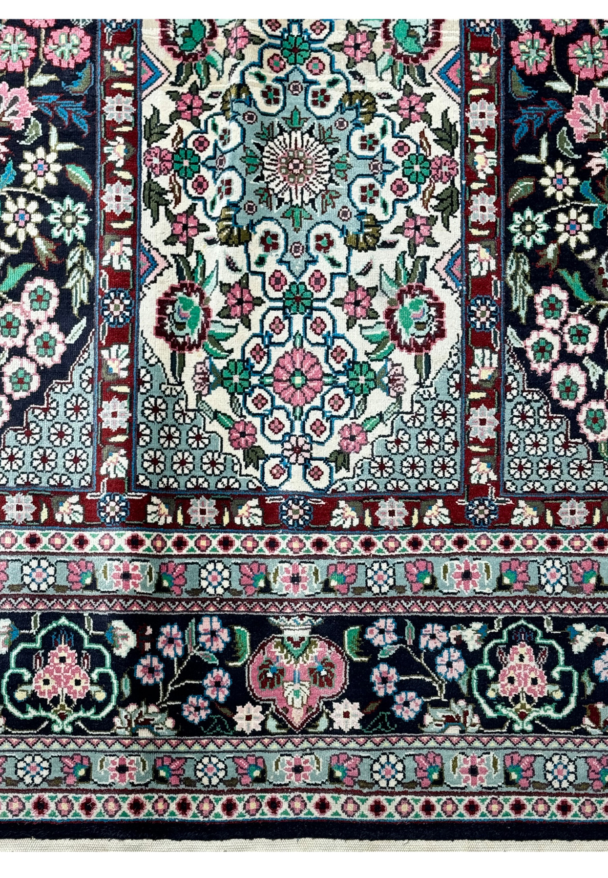 Zoomed-in view of the edge and fringe detailing of a luxurious Persian Qum silk rug