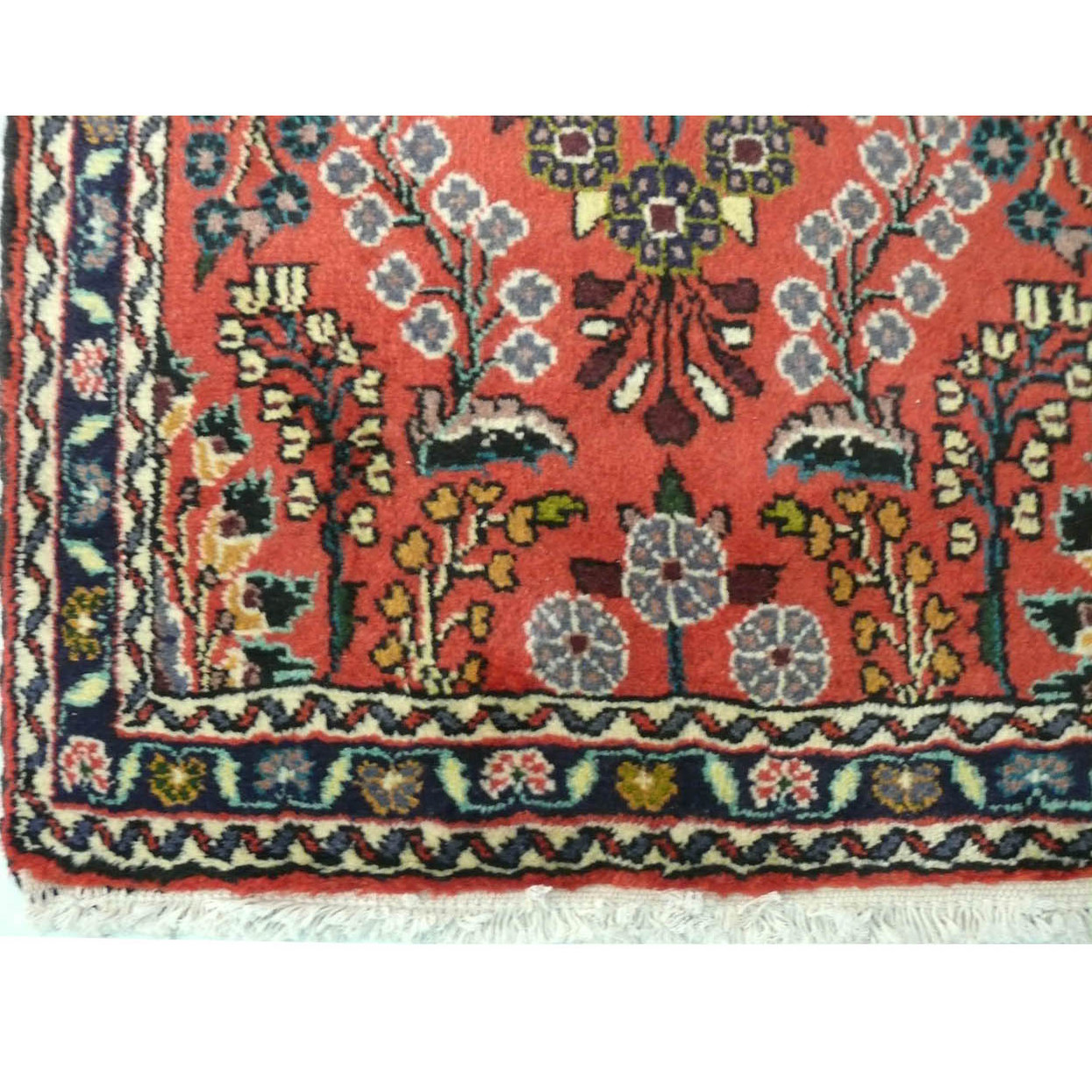 Close-up view of the Persian Darjazin runner rug showing the detailed patterns and the lush red field.