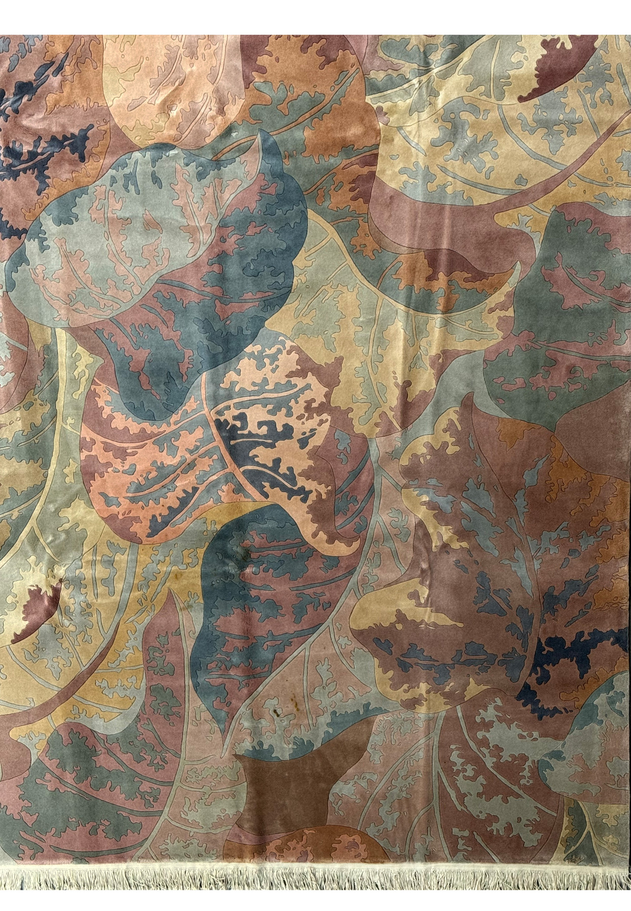 Close-up of the intricate leaf patterns on a Modern Art Deco Beijing rug with a focus on the interplay of terracotta and moss green hues.