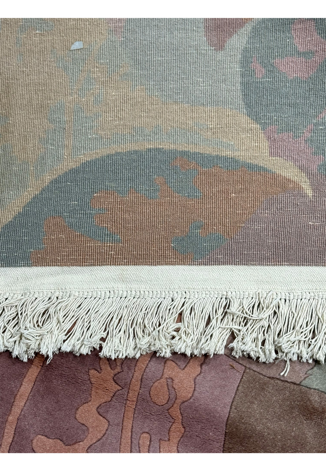 Edge detail of the Modern Art Deco Beijing rug, featuring the neatly tied off fringe and the sturdy backing material