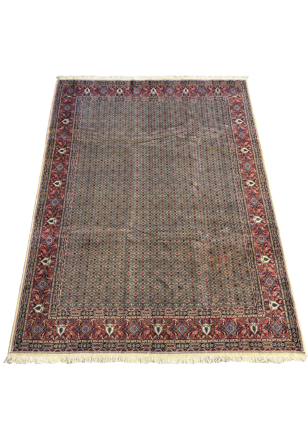 A perspective view of the Persian Moud Rug on a flat surface, illustrating the fine texture and the color contrast between the intricate central pattern and the bold border