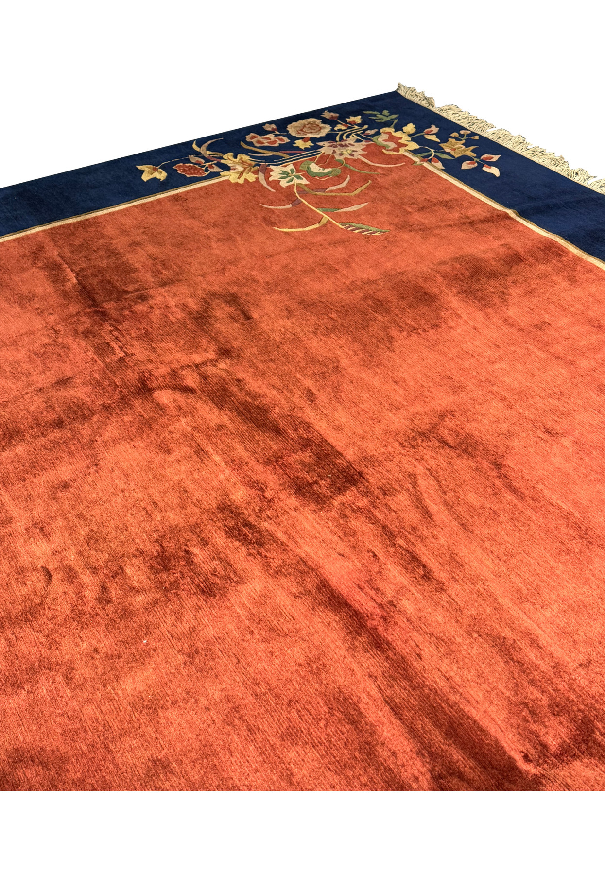 Close-up side view of the modern Oriental Art Deco rug, focusing on the texture and pile height of the burnt orange and navy blue areas.