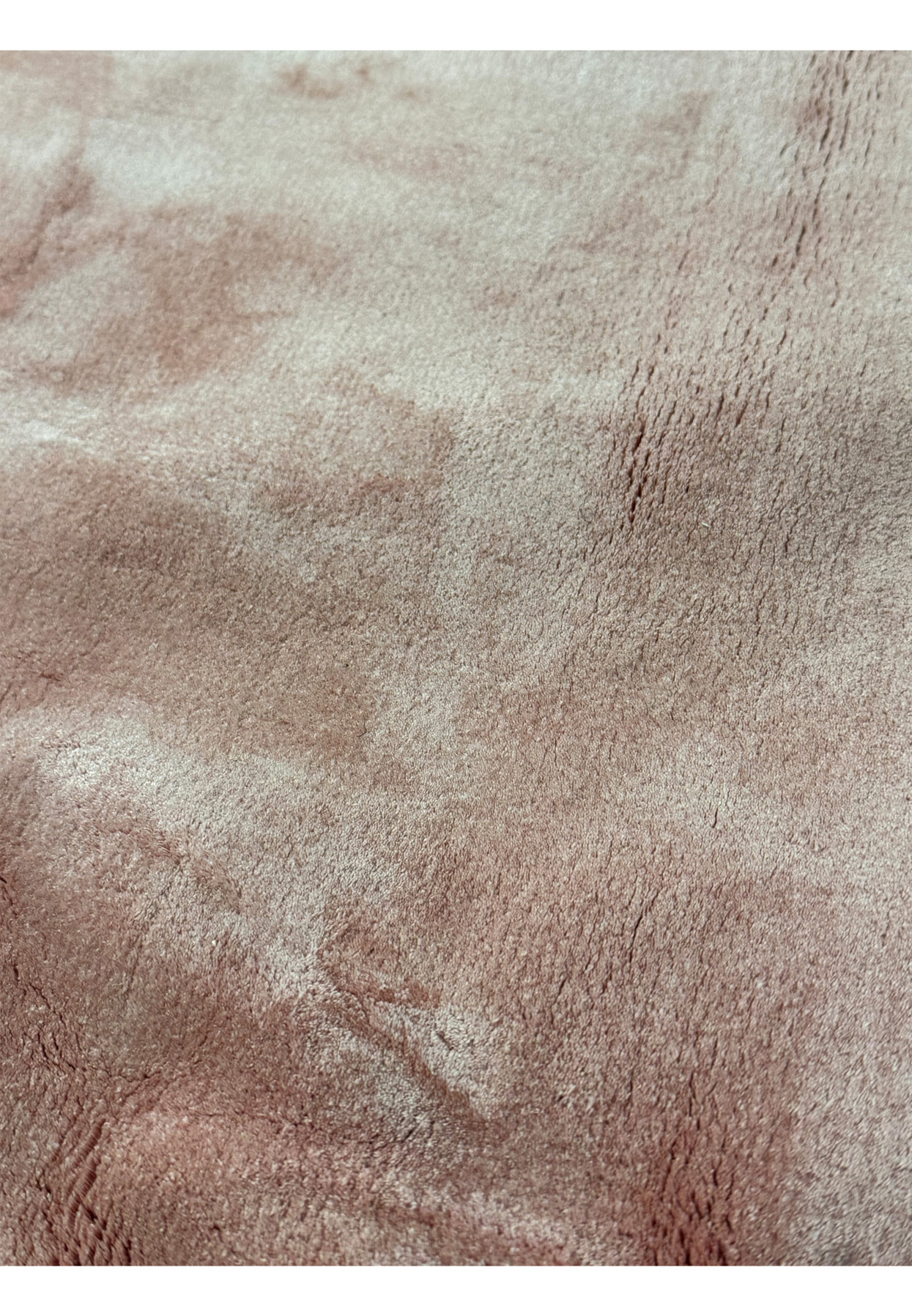 Close-up on the rug’s surface, showcasing the fine silk texture and subtle color variations.