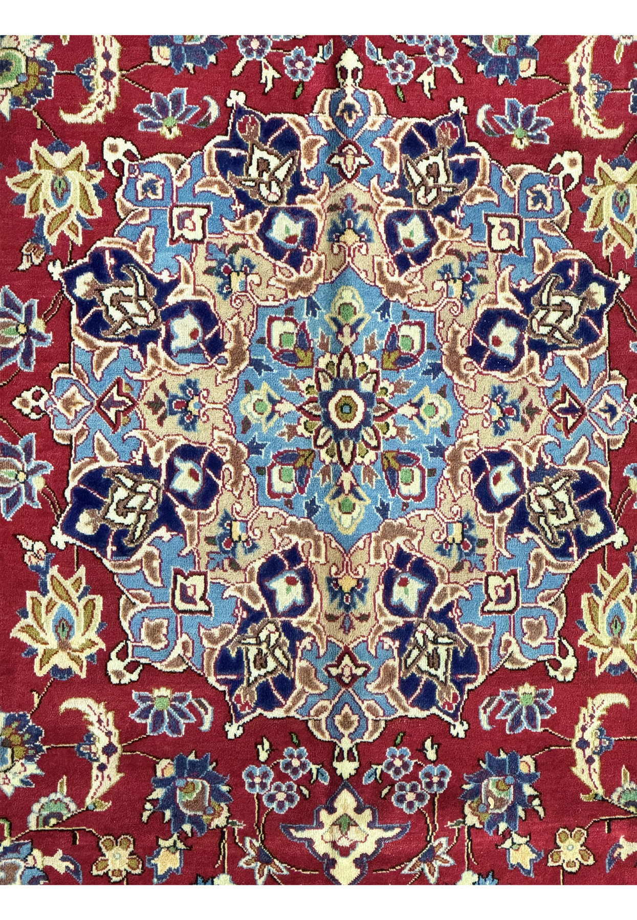 Close-up of a 10 x 15'6" Persian Isfahan rug's central medallion with a blue and cream floral design on a crimson background, surrounded by a complex pattern of flowers and vines