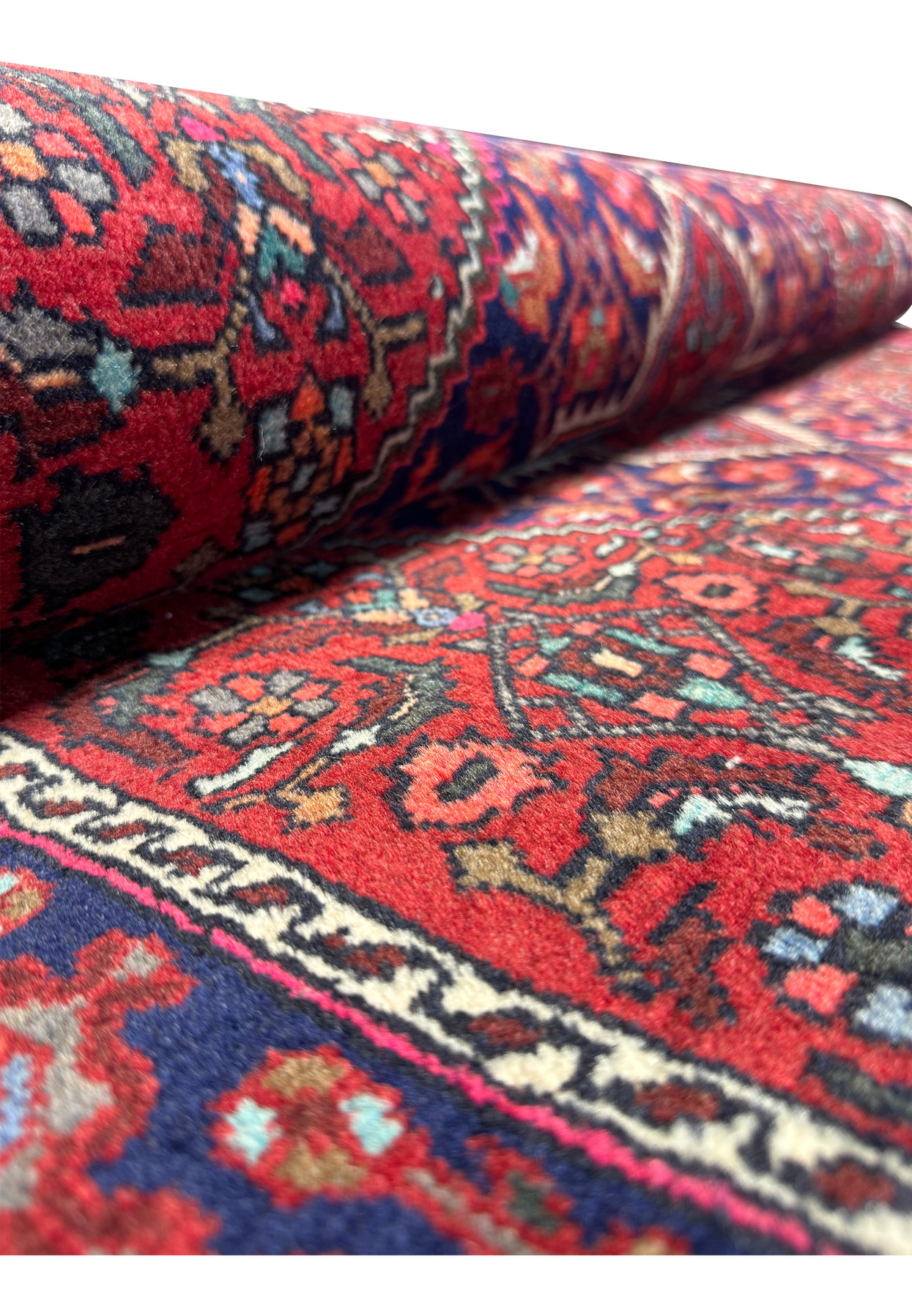 Side perspective of a Persian Gholtogh rug, with a focus on the seamless transition of patterns and the tidy fringe edge