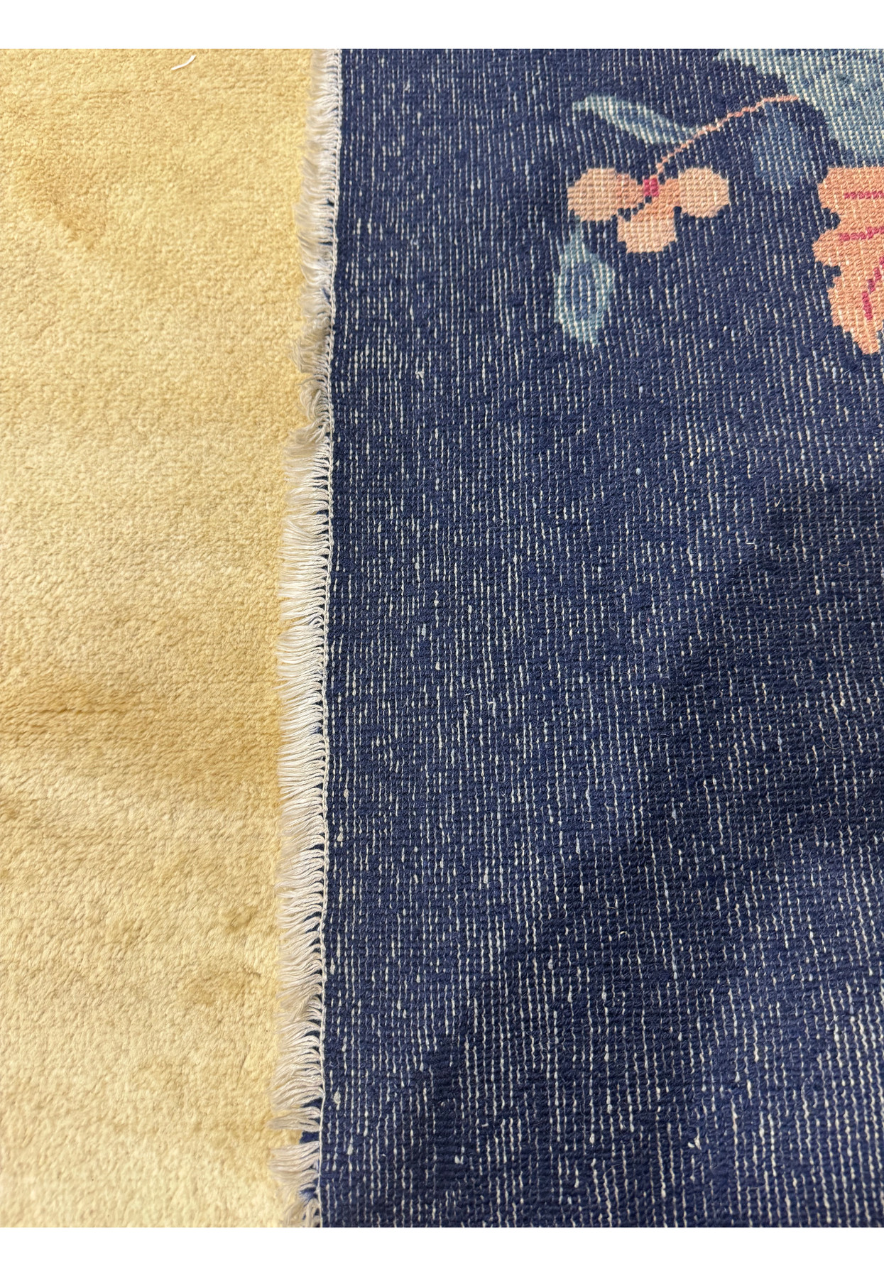 The back of a 10x14 Art deco vintage rug showing the perfect quality and weave of the rug from the 1960s