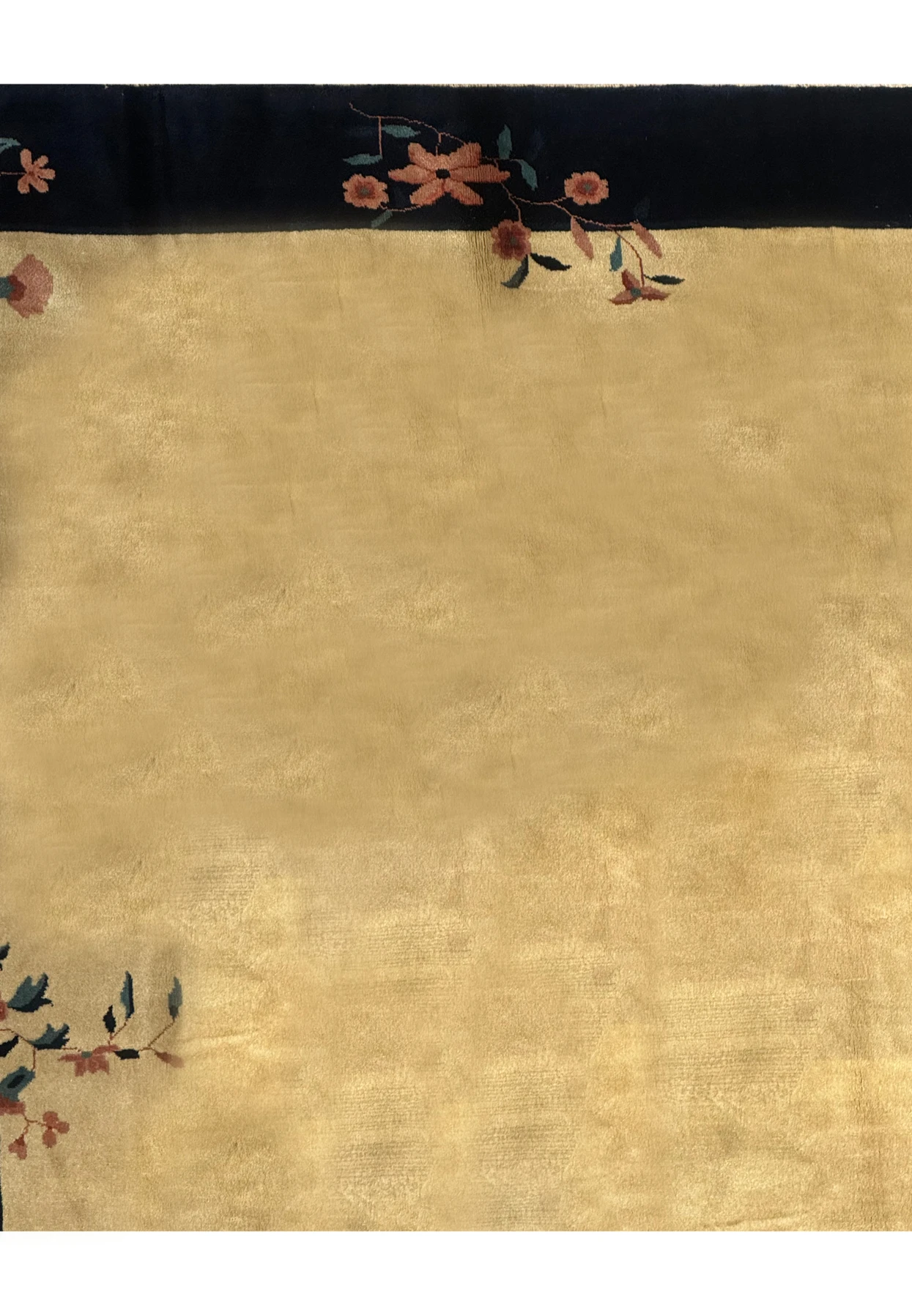 Magnified view of the corner detailing on a Vintage Art Deco Rug, highlighting the navy blue border and beige center with delicate floral art