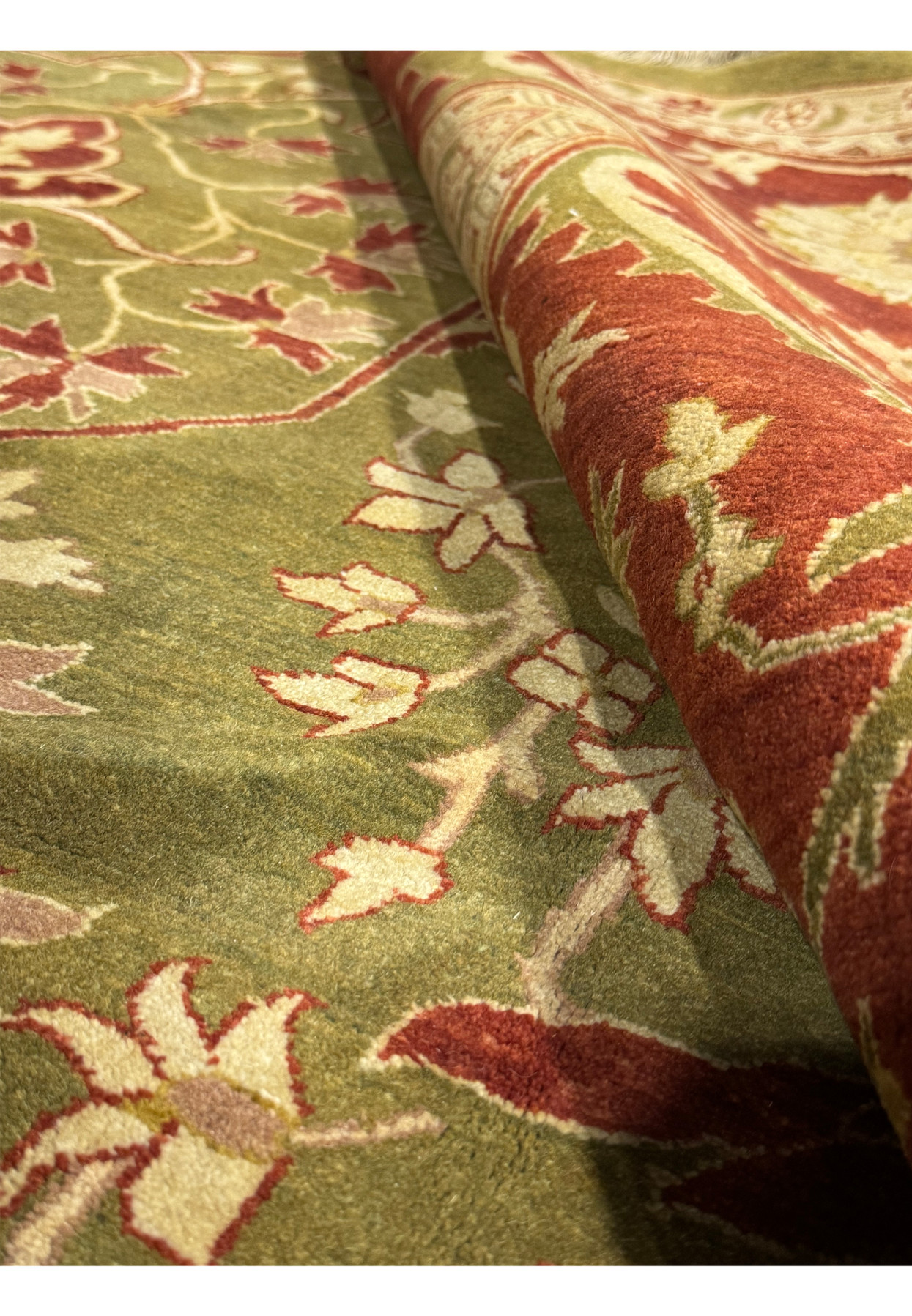 Angled perspective of a hand-knotted 10x15 Chobi Peshawar rug displaying the thickness and texture of the weave