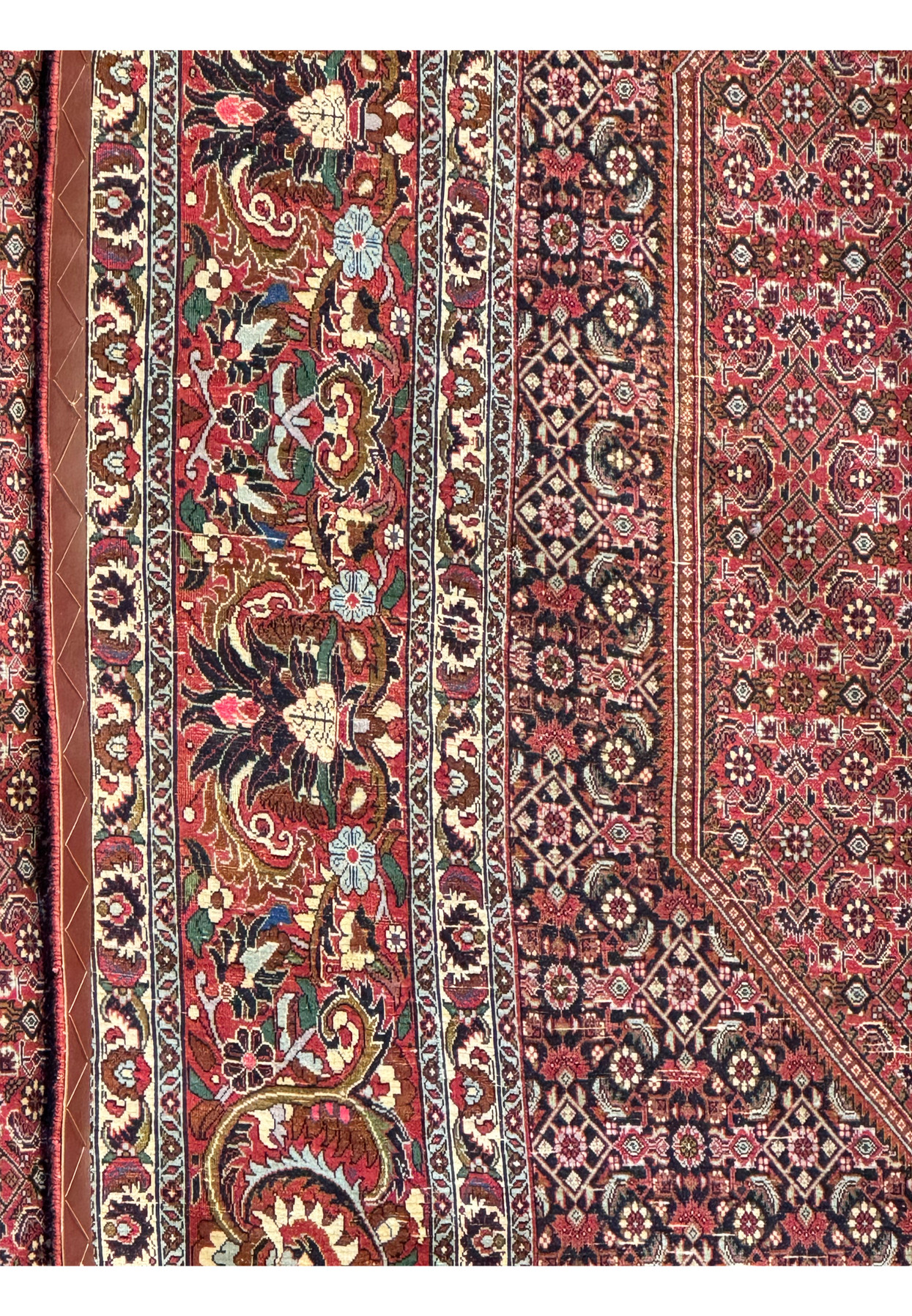 Close-up image of the reverse side of a Persian Bijar rug, displaying the high knot density that characterizes its fine craftsmanship. The tightly packed knots create a clear and precise mirror image of the intricate floral and geometric patterns visible on the rug's front, indicative of its quality and durability
