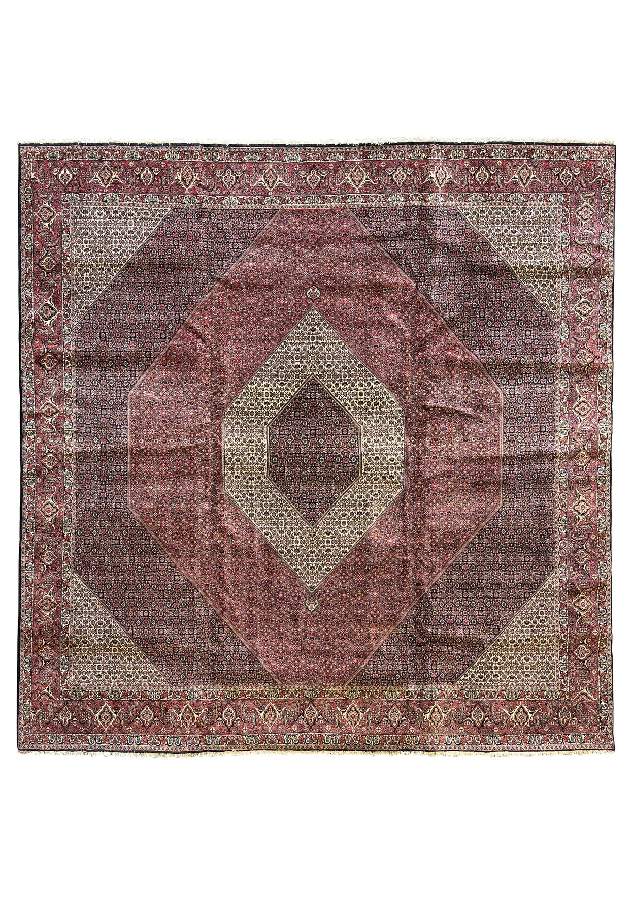 Full view of a grand 13 x 13 Persian Bijar square rug laid out to showcase its rare size and detailed geometric and floral designs in deep reds and blues