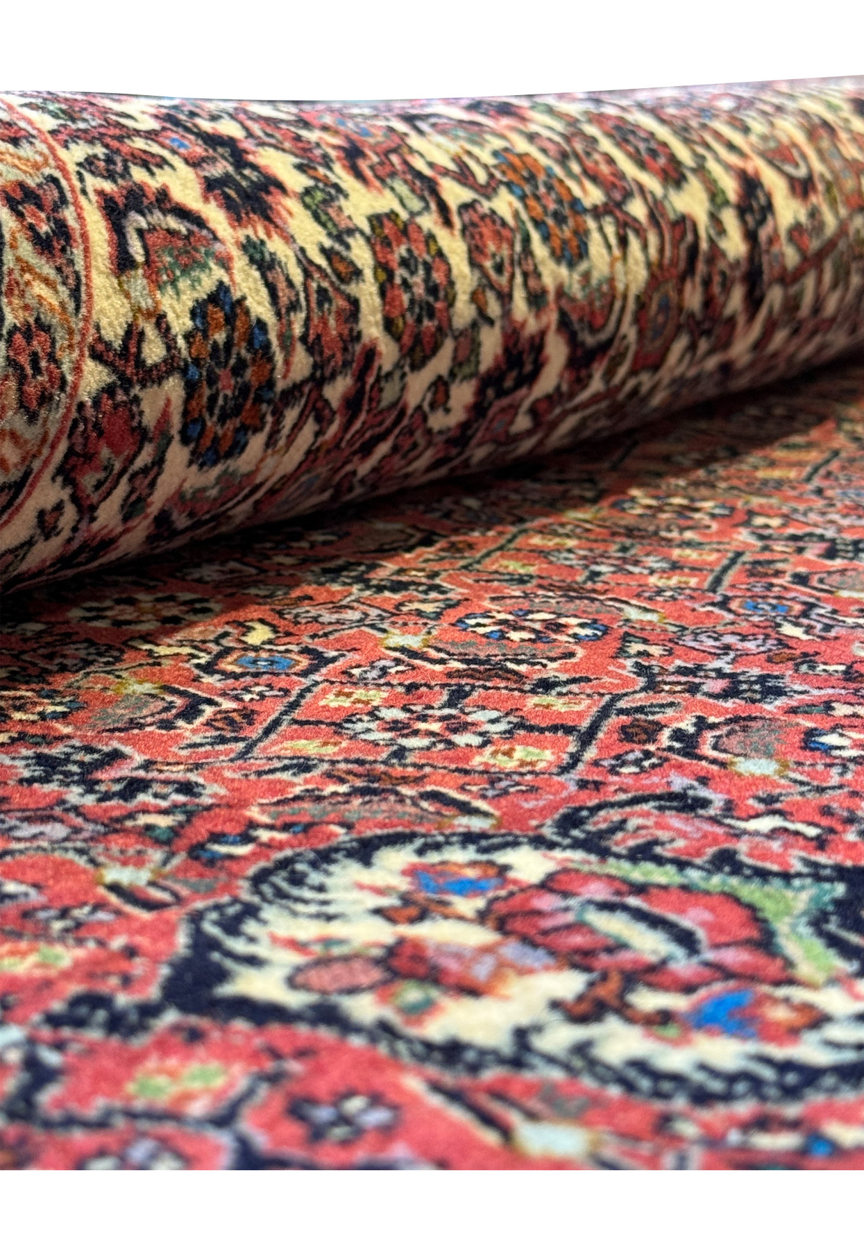 Part of a rolled Persian Bidjar rug (Iron Rug), highlighting the rug's thickness and the vibrancy of its outer patterns.