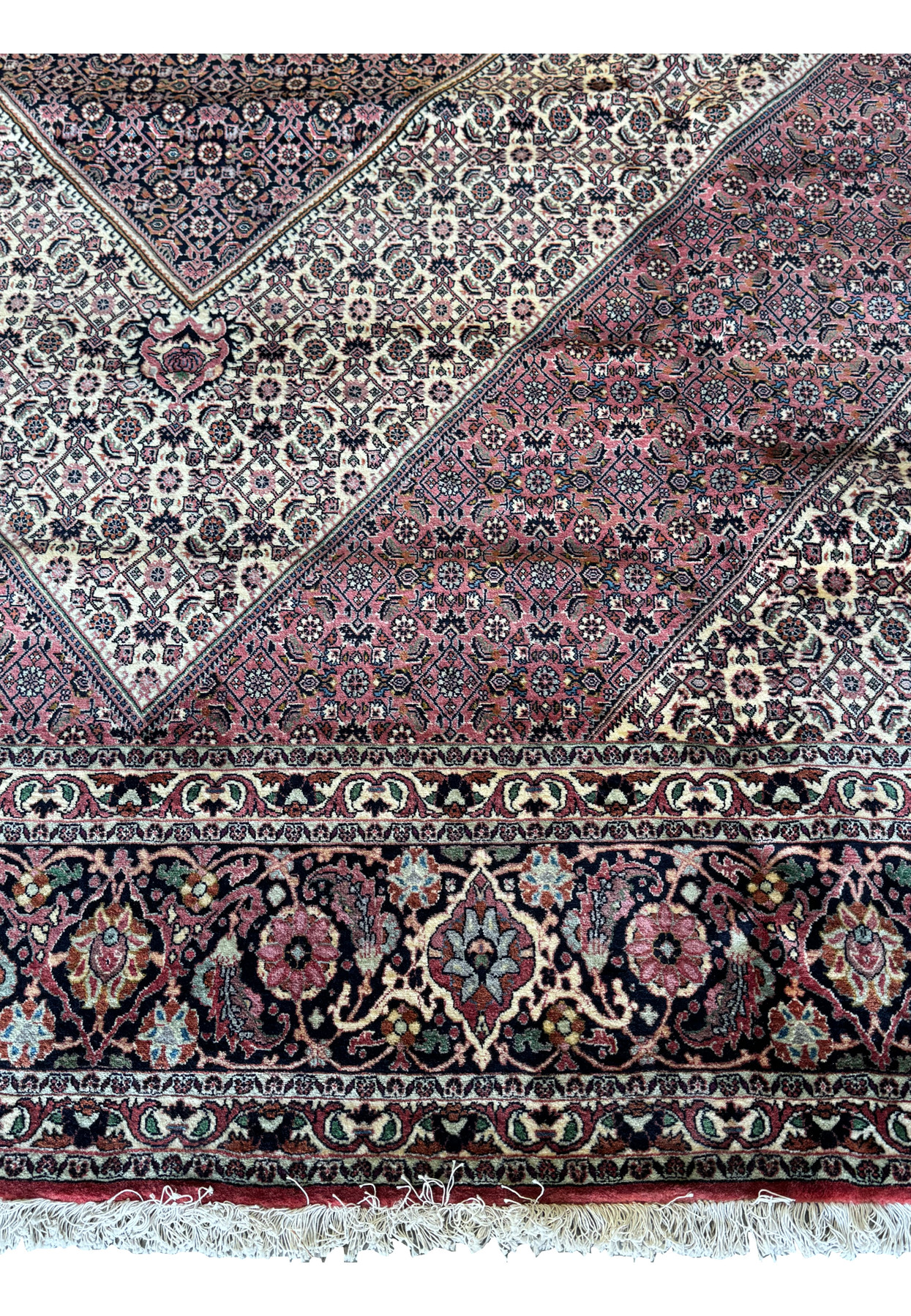 A corner view of the Persian Bijar rug, exhibiting its elaborate design and the tightness of the weave.
