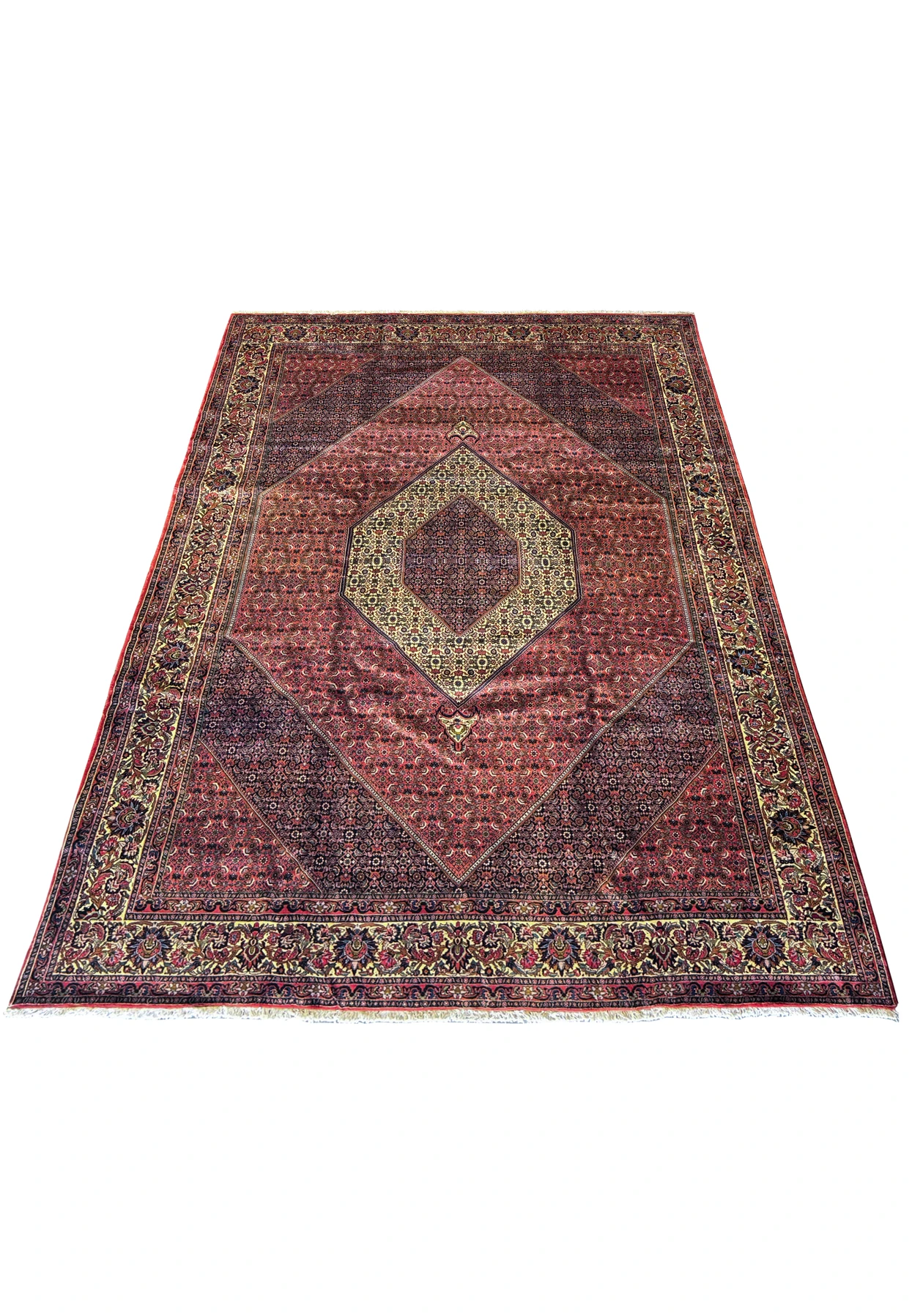 Angled full view of a Persian Bijar Rug on the floor, showcasing its expansive design and the rich contrast between the red field and elaborate border.