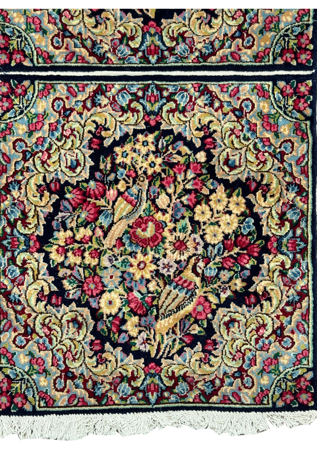 Close-up of a Persian Kerman rug's weave, revealing the high density of knots and color precision