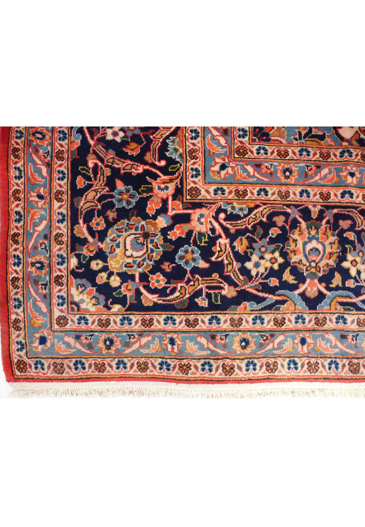 A close-up of the rug's fringe, showing the natural wool color and the quality of the finishing at the ends of the rug.