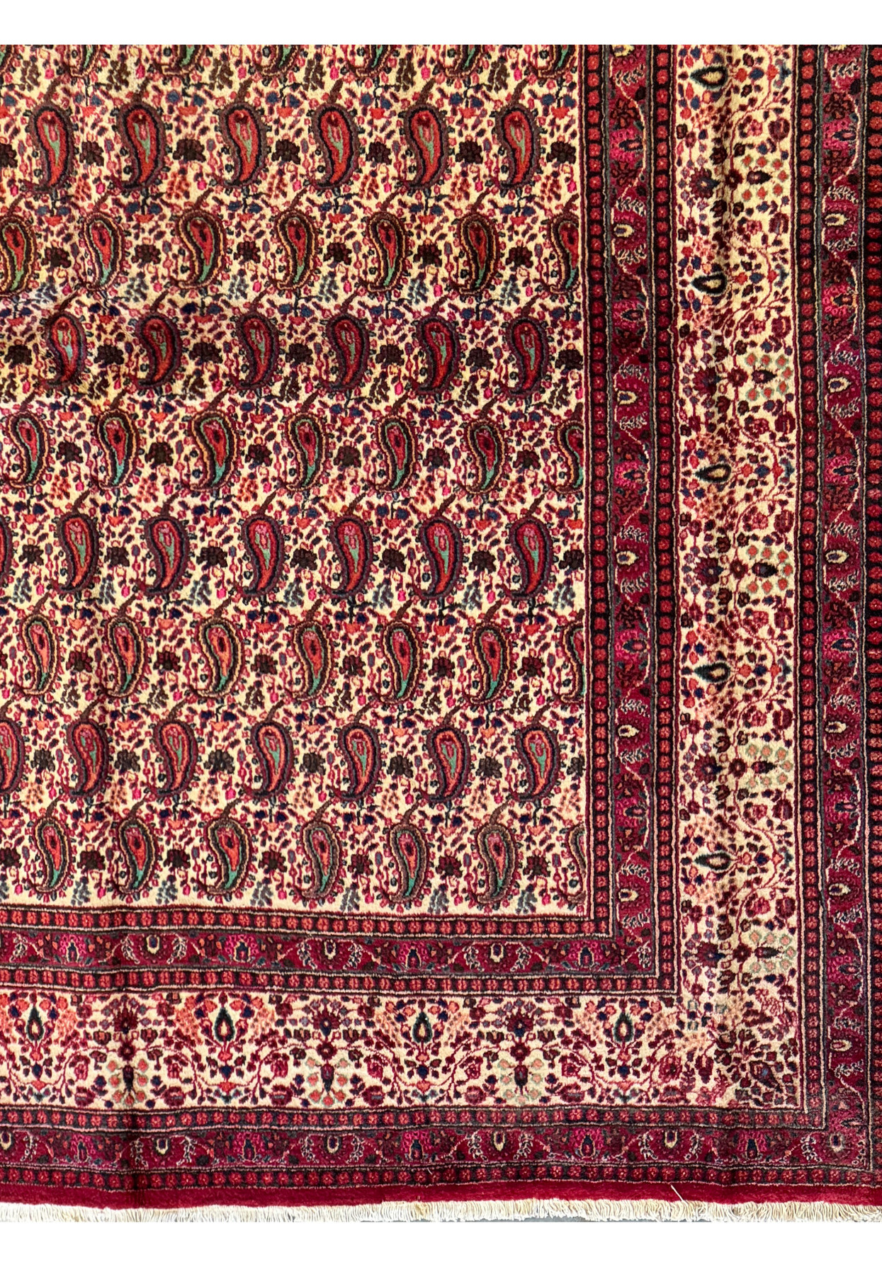Detailed perspective of the Persian Moud Rug's surface, illustrating the fine craftsmanship and rich texture of the woven wool with a deep red and blue color scheme