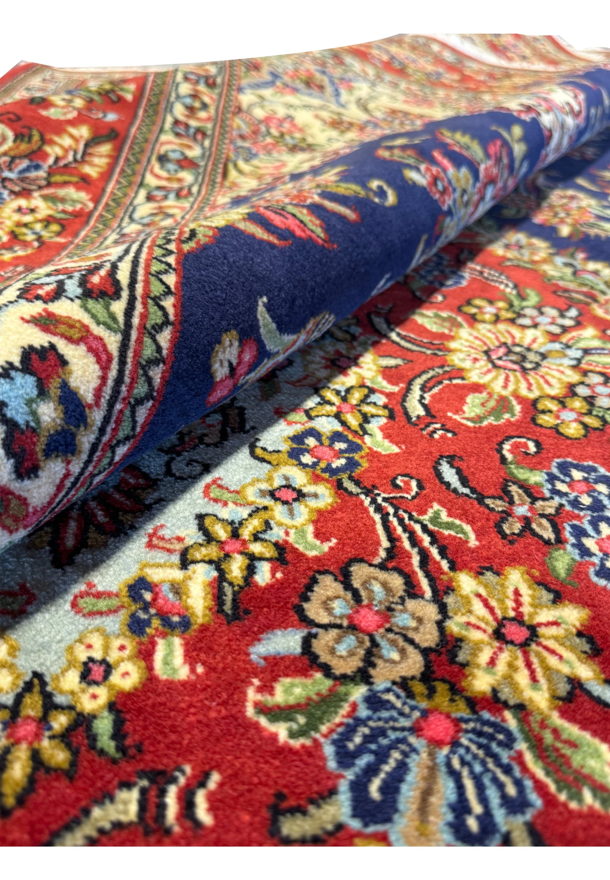 Image showing a Persian Qum Kork rug rolled up to display the thickness and quality of the weave, emphasizing the dense and plush texture of the fabric, indicative of high-quality craftsmanship