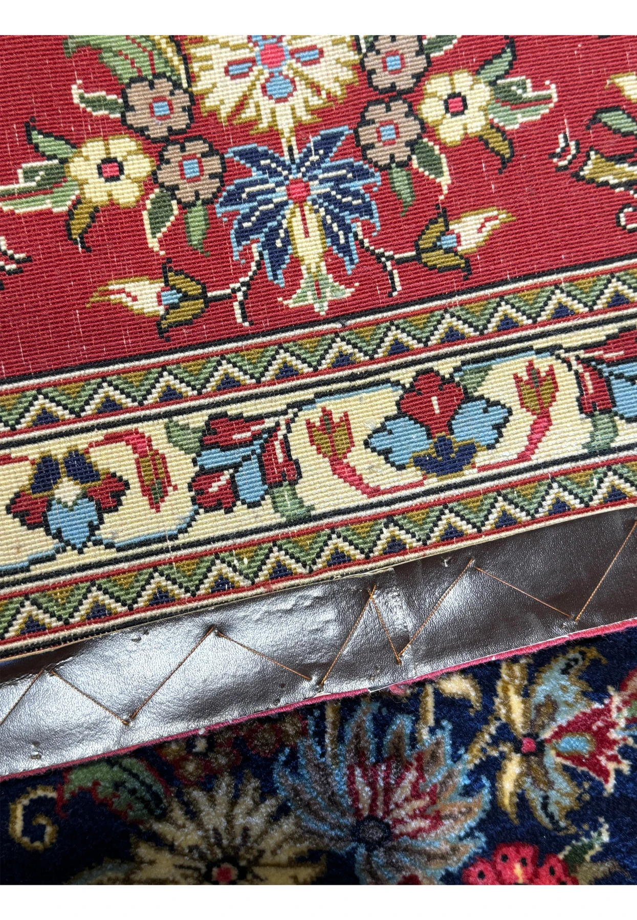 Close-up view of the back of a Persian Qum Kork rug, showing the tight weave and clean lines of the pattern, which mirror the front design, demonstrating the high-quality and durability of the rug.