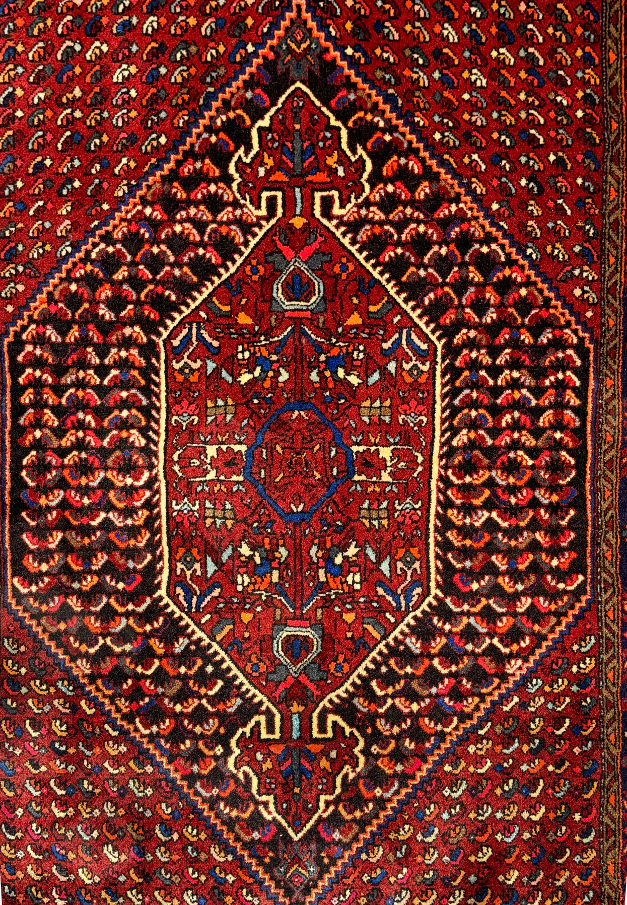 Close-up texture detail of a Persian Gholtogh rug, highlighting the tight weave and knot density that enhance the clarity of its red and blue geometric patterns.